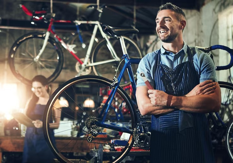 Bike mechanic in a busy bike shop